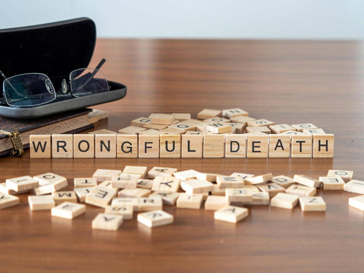 Tiles on a table that spells out “WRONGFUL DEATH” in El Paso.