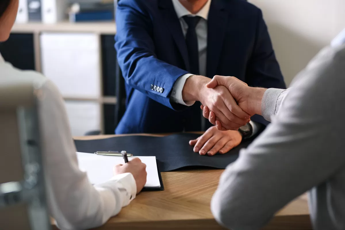 A wrongful death attorney shaking hands with a client in Missouri City.